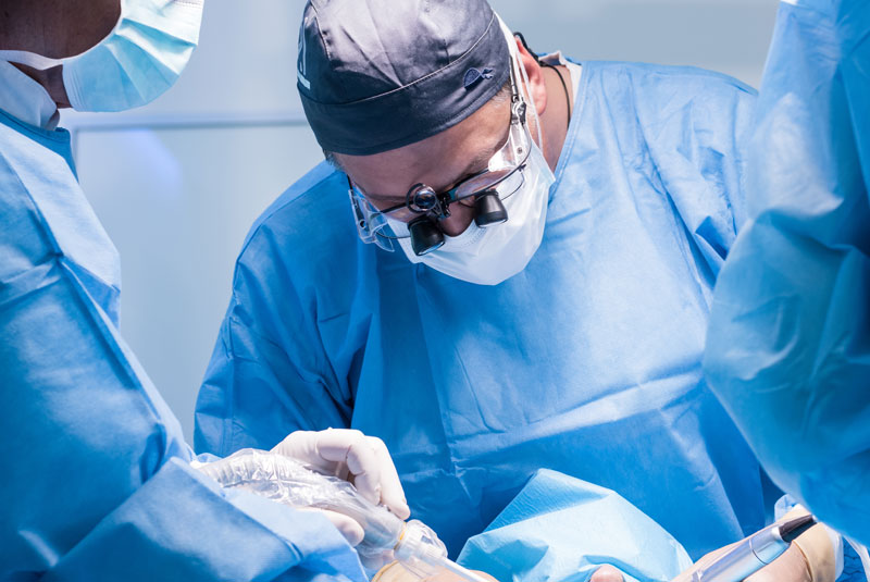 oral surgeon performing dental procedure