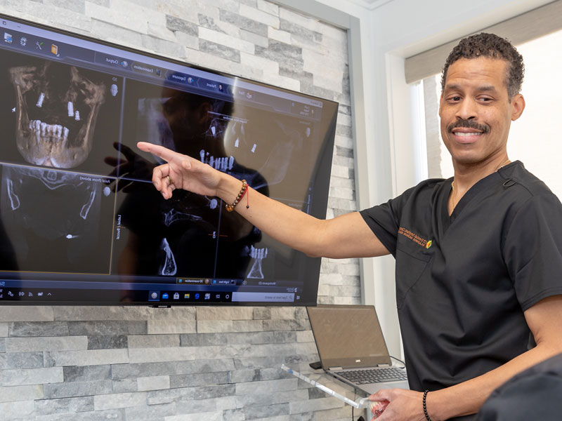 Dr. Gedeon showing a patient their xrays