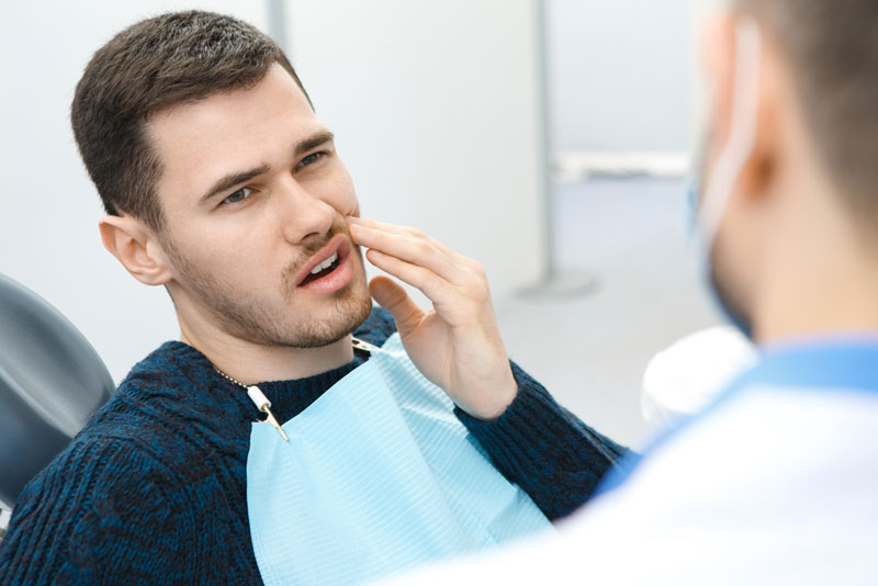 Dental Patient Suffering From Mouth Pain On A Dental Chair, In Danbury, CT